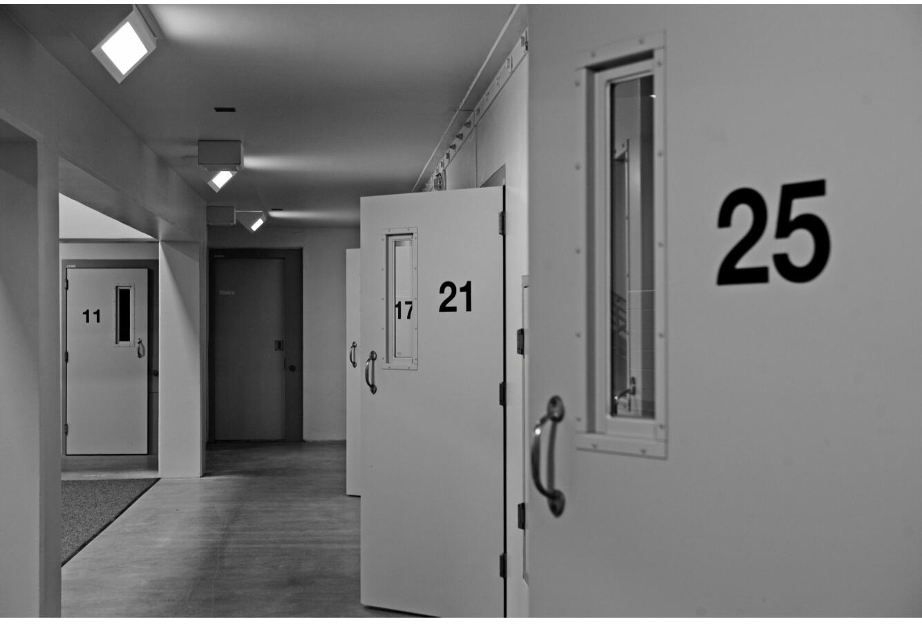 Fast Release Solutions A picture of steel cell doors 25, 26, and others inside a jail.