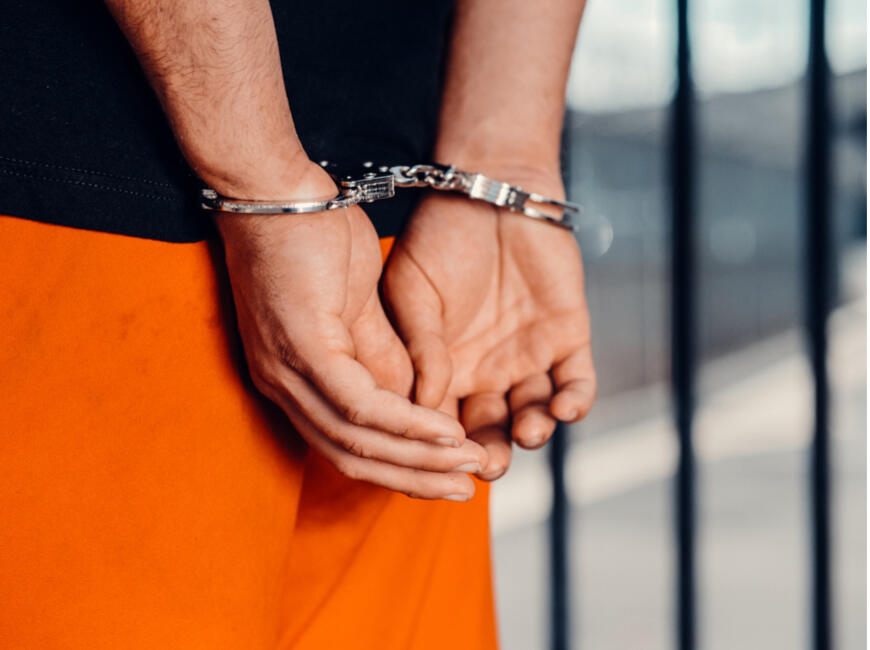 Tribal Bail Bonds in Oklahoma A pair of hands placed behind the back with handcuffs.